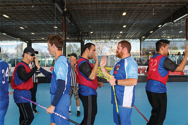 Athletes high-fiving at 2025 OC Floorball competition