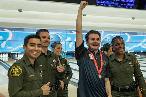 Officers and athlete with medal at 2025 OC bowling competition